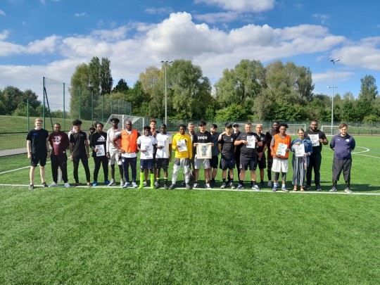 group of young people on football pitch